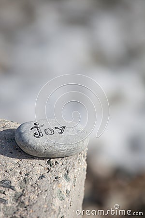 Words on pebble stones â€“ motivational concept slogan â€“ word joy Stock Photo